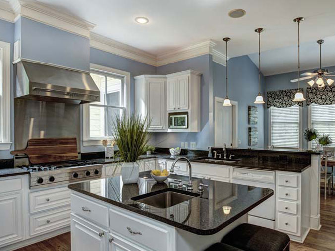 Kitchen with blac stone counters and stainless appliances and fixtures