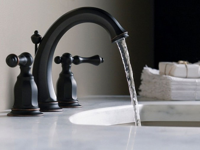 Closeupo of bathroom faucet with running water